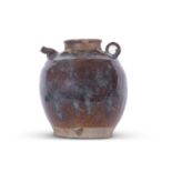 Large pottery jar, possibly Khmer, with streaked chocolate brown glaze with spout and small loop