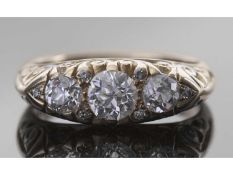 Diamond three stone ring centring a round old cut diamond, 0.65ct approx, flanked by two further old