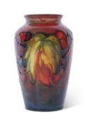 Small Moorcroft vase in the leaf and berry pattern on flambe ground