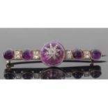 Antique amethyst and diamond set brooch centring a round amethyst cabochon applied with a diamond
