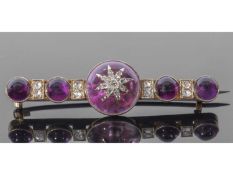 Antique amethyst and diamond set brooch centring a round amethyst cabochon applied with a diamond