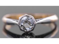 Antique diamond single stone ring featuring a old cut diamond in a rub-over setting, raised