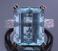 Large aquamarine dress ring of stepped cut, 15.63 x 12.21 x 8.56mm, raised in between textured