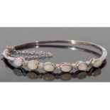 9ct gold opal and diamond set hinged bracelet, the top section with six oval cut cabochon opals,