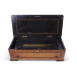 Large Swiss music box veneered with birds eye maple and decorated with central inlaid star, the