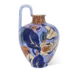 Bursley ware ewer with a design of flowers on blue ground by Frederick Rhead, 22cm high