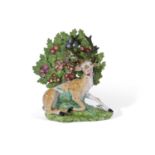 Early 19th century Derby porcelain model of a stag on green ground, red factory mark to base and