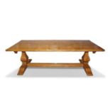 20th century oak refectory dining table, the plank top raised on heavy end supports with central