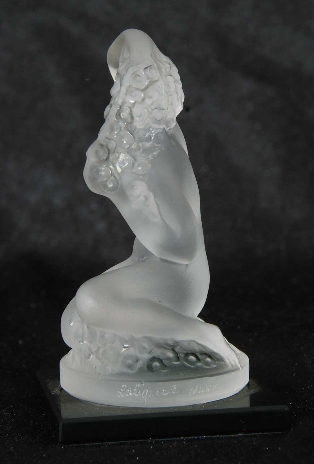 Small Lalique model of a nude lady crouching on circular base, mounted on a black glass - Image 4 of 4