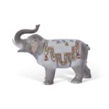 Continental porcelain model of an elephant with trunk raised, the back with a floral design and with