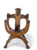 Unusual Gothic Savonarola type chair, the back with carved mask and wing detail over an X-shaped