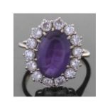 Large amethyst and diamond set dress ring, the oval faceted amethyst 14.11 x 9.75 x 6.23mm, within a