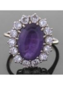 Large amethyst and diamond set dress ring, the oval faceted amethyst 14.11 x 9.75 x 6.23mm, within a