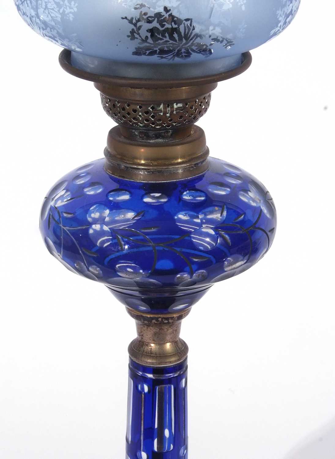 Late 19th century oil lamp, the blue glass shade with floral design above a Bohemian style blue - Image 3 of 4
