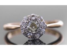 Diamond cluster ring centring an old cut diamond surrounded by eight small diamonds in illusion