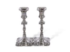Pair of Edwardian silver encased candlesticks in early 18th century style, having loaded shaped
