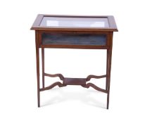 Edwardian mahogany and inlaid bijouterie table of rectangular form, the glazed hinged lid opening to