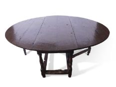 Large oak gateleg table in the 17th century style, the oval top supported on a frame with single