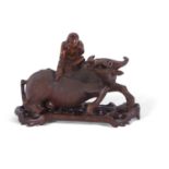 Chinese wooden carving of a man on a buffalo on pierced wooden base