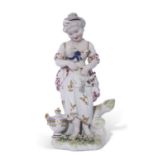 18th century Derby patch mark figure of a young girl holding a lamb on green base decorated with