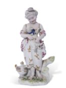 18th century Derby patch mark figure of a young girl holding a lamb on green base decorated with