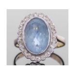 Large aquamarine and diamond cluster ring, the oval faceted aquamarine 12 x 8 x 6.6mm approx, framed
