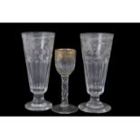 Small cordial glass with gilded floral design above a faceted stem, together with two large