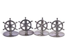 Of nautical interest - a cased set of four silver menu holders in the form of six-spoked ship's