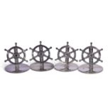 Of nautical interest - a cased set of four silver menu holders in the form of six-spoked ship's