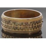 Antique yellow metal wide hinged bracelet of oval form, the top section with a geometric and bead