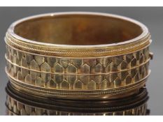 Antique yellow metal wide hinged bracelet of oval form, the top section with a geometric and bead