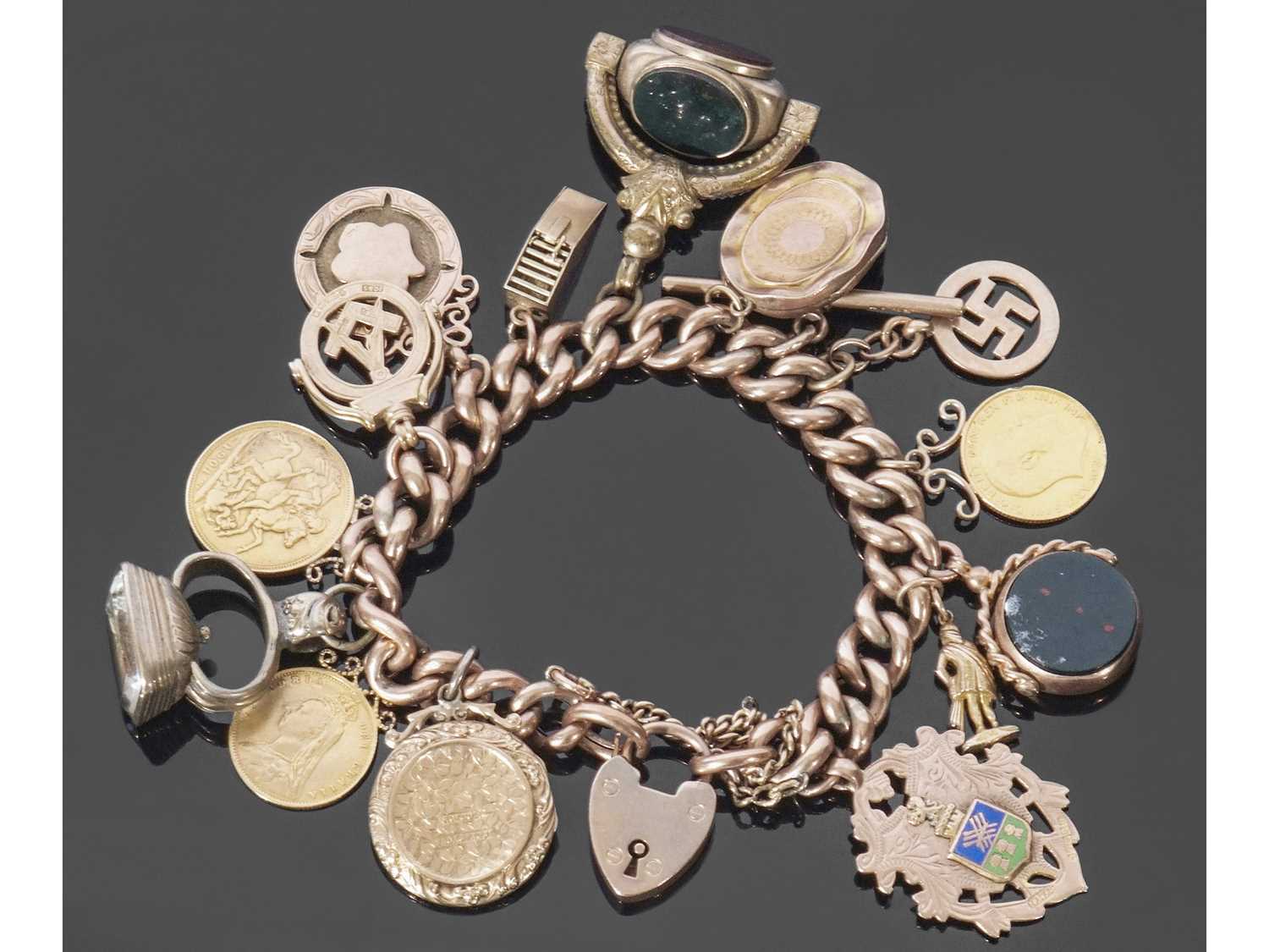 9ct rose gold curb link bracelet, suspending various charms and coins to include a Victorian