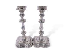 Pair of early Georgian style silver encased candlesticks, having shaped and moulded bases, knopped