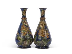 Large pair of Lambeth Doulton faience vases of pear shape, decorated with floral designs on a blue