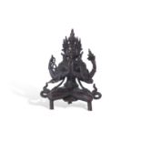 Tibetan bronze figure of a Bodhisattva in classic pose, seated on three stub feet, with metal