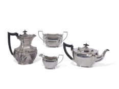 George V four piece tea service of shaped oval form with fluted corners, angular handles