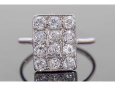 Art Deco diamond cluster ring, the rectangular panel set with 12 small round old cut brilliant
