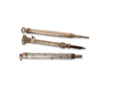 Mixed Lot:: Three gold plated small propelling pencils, the first of plain cylindrical form, stamped
