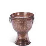 An unusual large circular pedestal copper double handled brazier with planished body together with