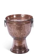 An unusual large circular pedestal copper double handled brazier with planished body together with