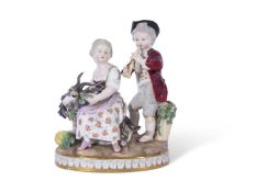 19th century Meissen group of two children, the girl sitting on a goat surrounded by bunches of