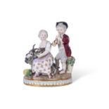 19th century Meissen group of two children, the girl sitting on a goat surrounded by bunches of