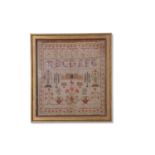19th century needlework sampler decorated with rows of letters and large panel of a country house