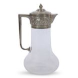 Late Victorian clear glass claret jug with star cut base, angular handle, floral and foliate