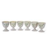 Set of six Belleek egg cups decorated with shamrocks, one egg cup with first period black mark to