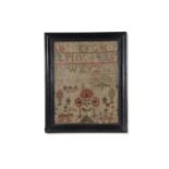 19th century needlework sampler decorated with rows of letters above a garden scene with large