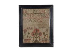 19th century needlework sampler decorated with rows of letters above a garden scene with large
