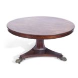 Regency rosewood dining table having a figured rosewood veneered top with beaded edges, between a