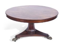 Regency rosewood dining table having a figured rosewood veneered top with beaded edges, between a