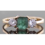 Emerald and diamond three stone ring centring a rectangular cut emerald, 6.16 x 5.12 x 3.6mm,